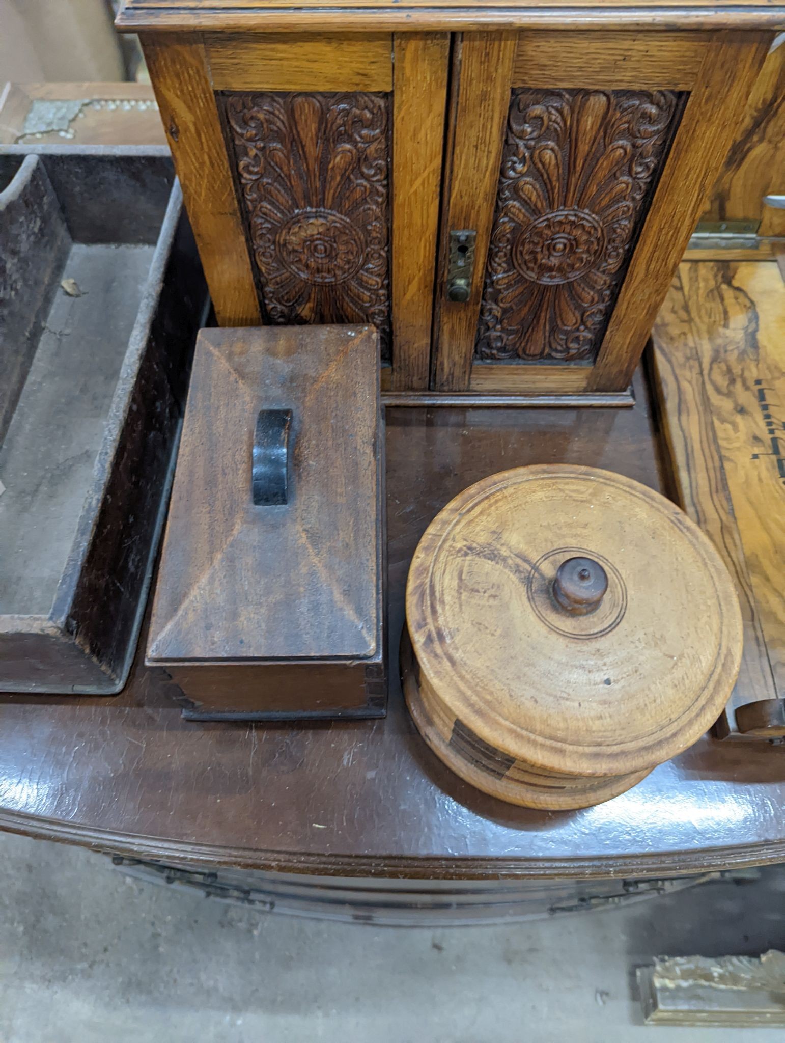 A Victorian oak smoker's box, two olive wood book rests, money box, tray, clock and a cutlery box and another